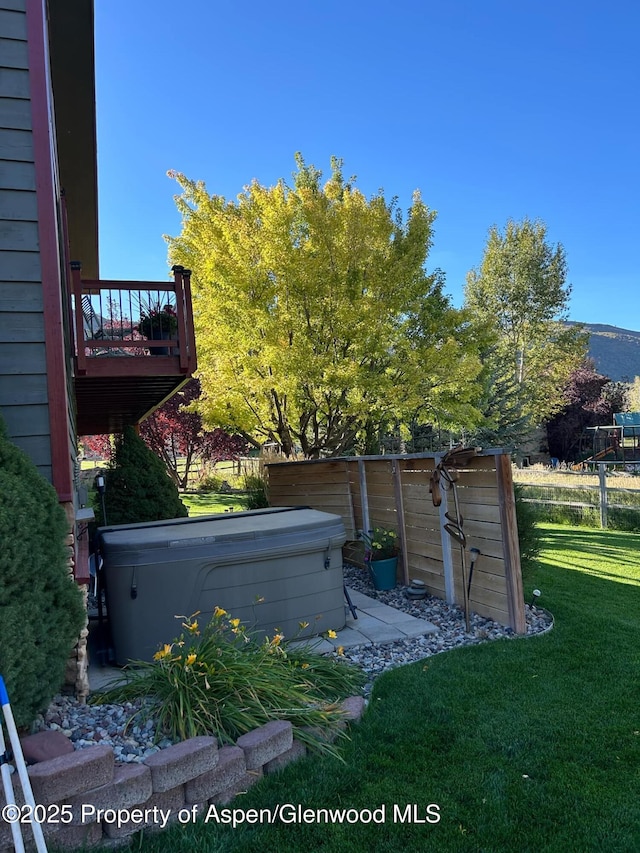 exterior space with a deck and a hot tub