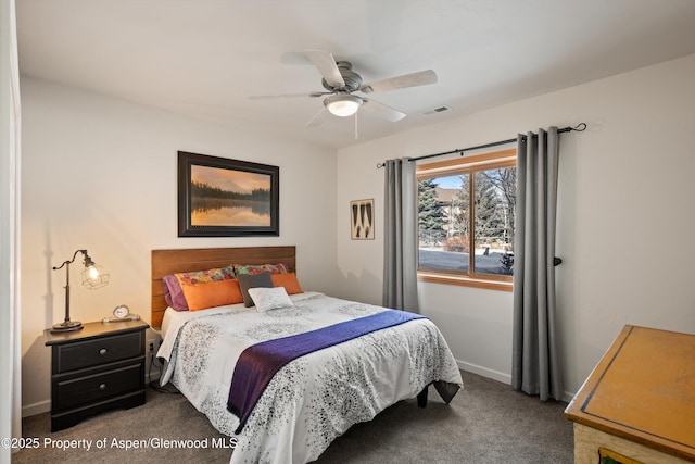 bedroom featuring ceiling fan and dark carpet