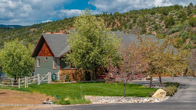 10 Laird Ln, Glenwood Springs, CO 81601 - view of front of home featuring stone siding, a shingled roof, and a gate