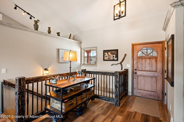 kitchen with a kitchen breakfast bar, decorative light fixtures, high vaulted ceiling, and high quality fridge