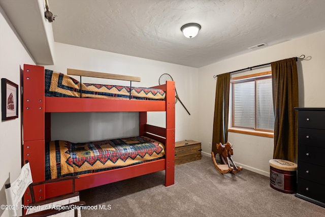 carpeted bedroom featuring a textured ceiling