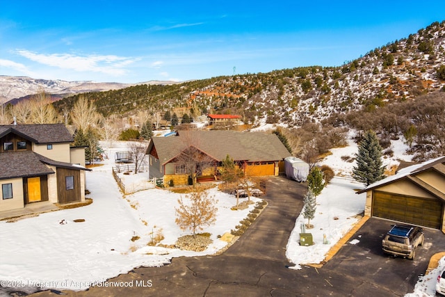 snowy aerial view with a mountain view