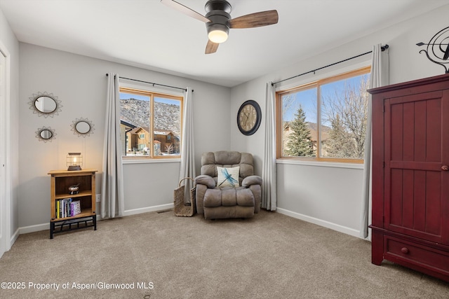 sitting room featuring ceiling fan and light colored carpet