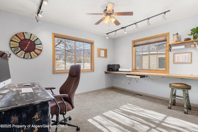 office space with ceiling fan, light colored carpet, and track lighting