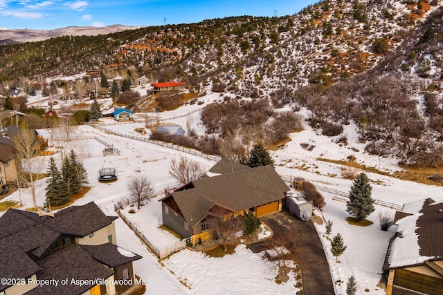 snowy aerial view with a mountain view