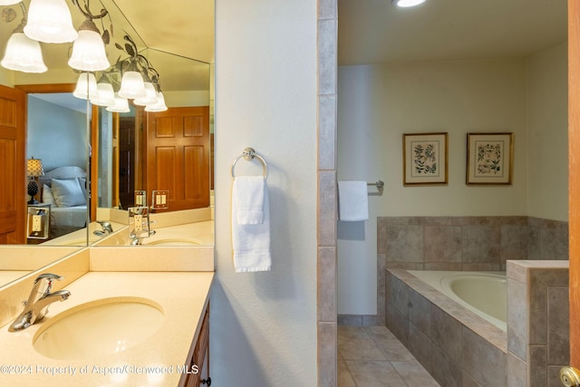 bathroom featuring tile patterned floors, vanity, and a relaxing tiled tub