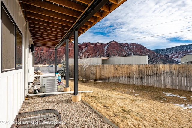 view of yard featuring a mountain view and central air condition unit