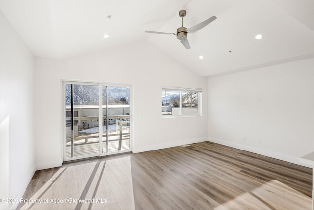 empty room with light hardwood / wood-style flooring, high vaulted ceiling, and ceiling fan