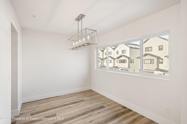 unfurnished dining area with light wood-type flooring