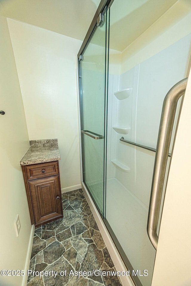 bathroom with vanity and a shower with shower door