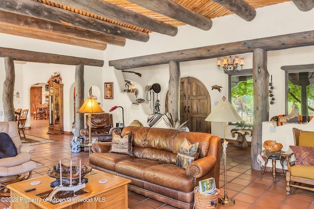 living room featuring beam ceiling, a chandelier, tile patterned flooring, and wood ceiling