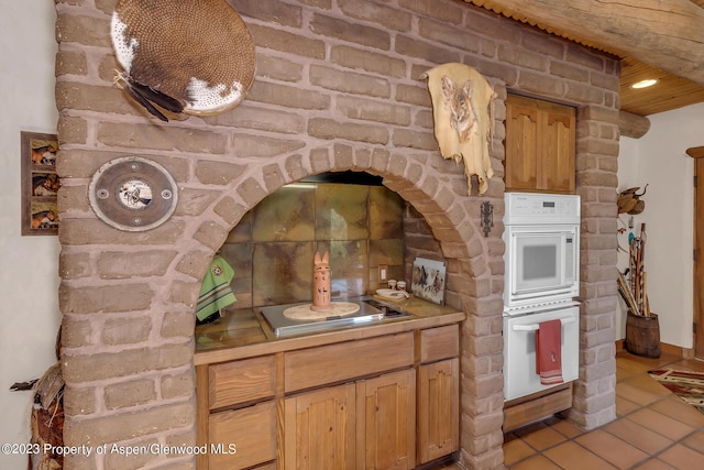 kitchen featuring white double oven and stovetop