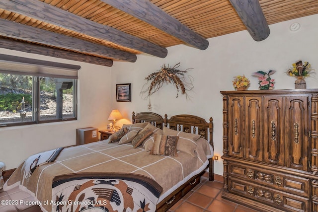 bedroom with beam ceiling, light tile patterned flooring, and wood ceiling