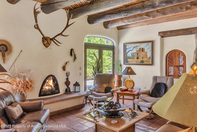 living room with beamed ceiling and tile patterned floors