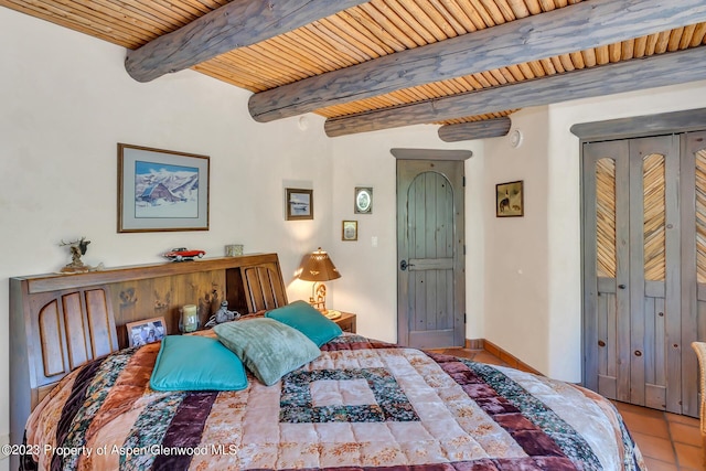 bedroom featuring beam ceiling, light tile patterned flooring, and wood ceiling