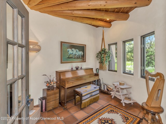 miscellaneous room featuring light tile patterned floors, lofted ceiling with beams, and wood ceiling