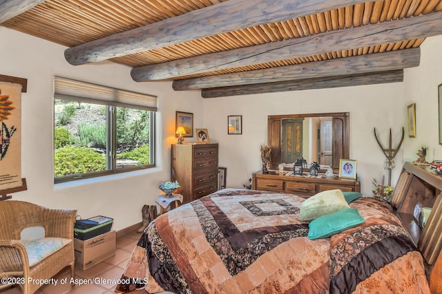 tiled bedroom featuring beam ceiling and wooden ceiling