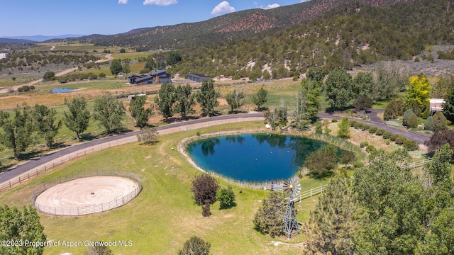 birds eye view of property with a water and mountain view