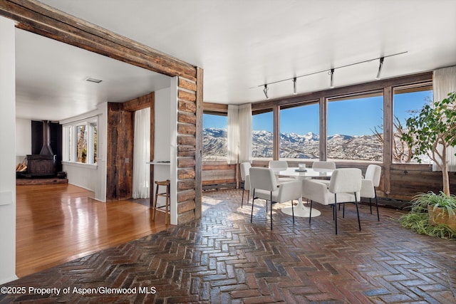 260 Star Mesa Rd, Aspen, CO 81611 - dining room featuring rail lighting, a mountain view, and a wood stove