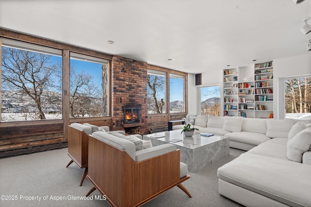 260 Star Mesa Rd, Aspen, CO 81611 - carpeted living room with built in features and a brick fireplace