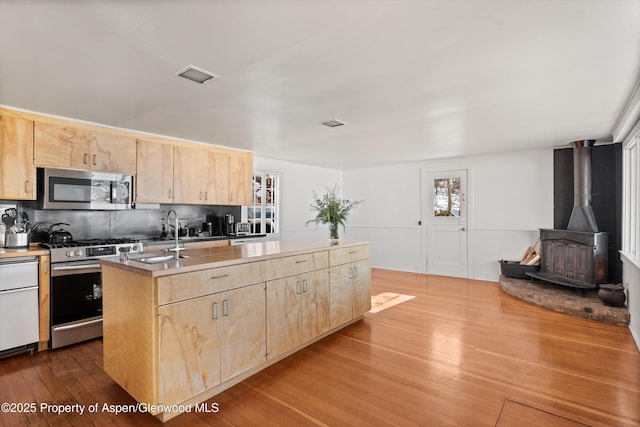 260 Star Mesa Rd, Aspen, CO 81611 - kitchen featuring light brown cabinetry, appliances with stainless steel finishes, a sink, a center island with sink, and wood-type flooring