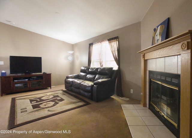 living room featuring light tile patterned flooring and a tile fireplace