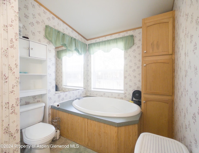 bathroom featuring tile patterned flooring, a bathtub, toilet, and ornamental molding