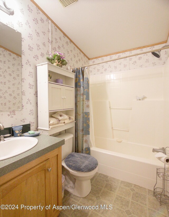 full bathroom featuring shower / bath combo, ornamental molding, vanity, toilet, and lofted ceiling