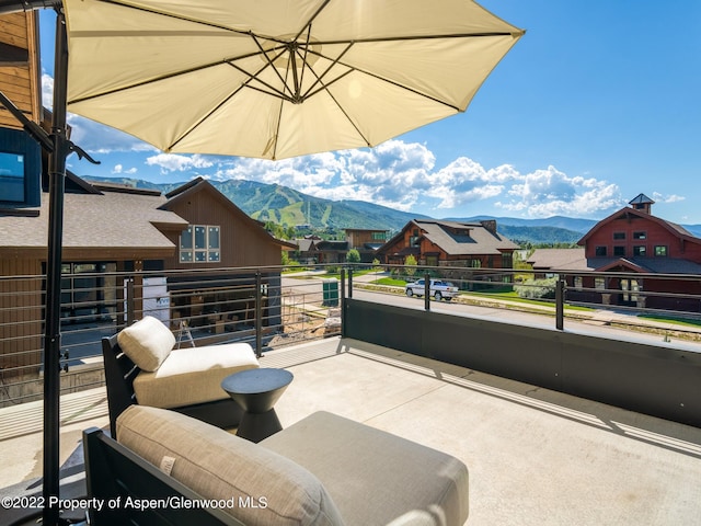 view of patio / terrace with a balcony and a mountain view