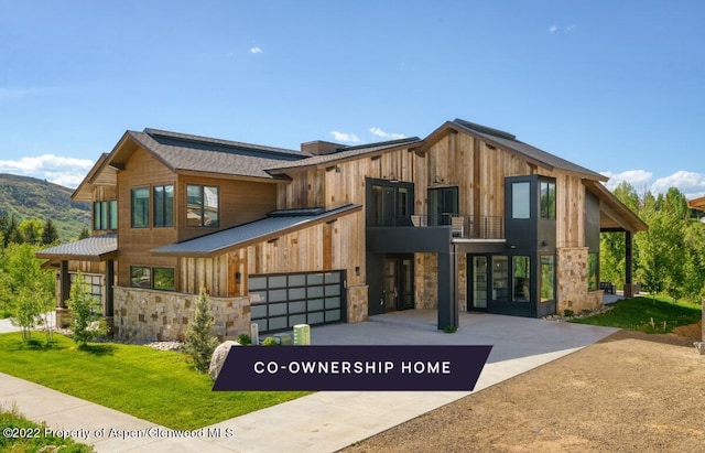 contemporary home featuring a balcony and a garage