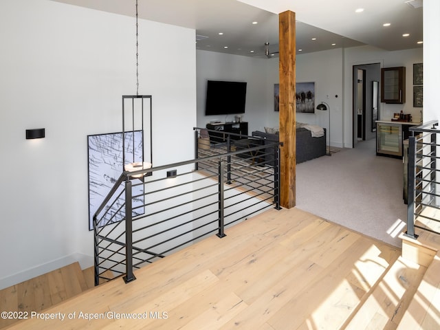 stairway with hardwood / wood-style floors