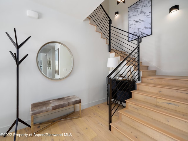 stairs featuring hardwood / wood-style floors