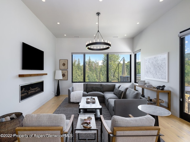 living room featuring a notable chandelier and light hardwood / wood-style floors