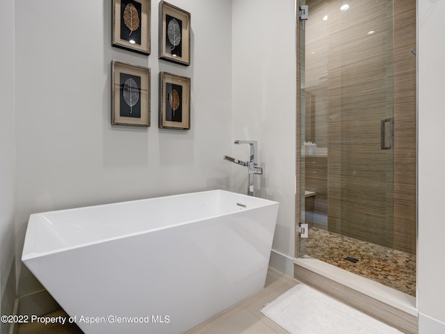 bathroom featuring separate shower and tub and tile patterned floors