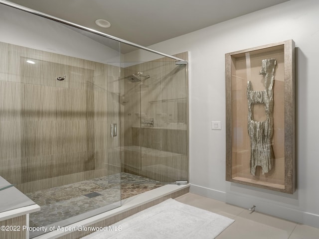 bathroom featuring tile patterned flooring and a shower with shower door