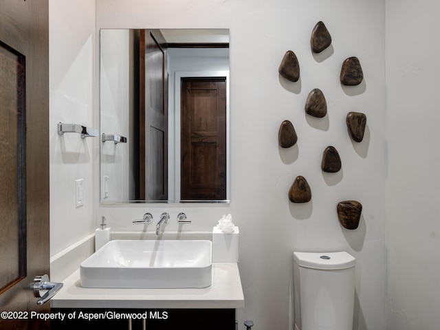 bathroom featuring toilet and vanity