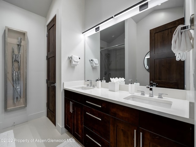 bathroom featuring lofted ceiling, tile patterned flooring, walk in shower, and vanity