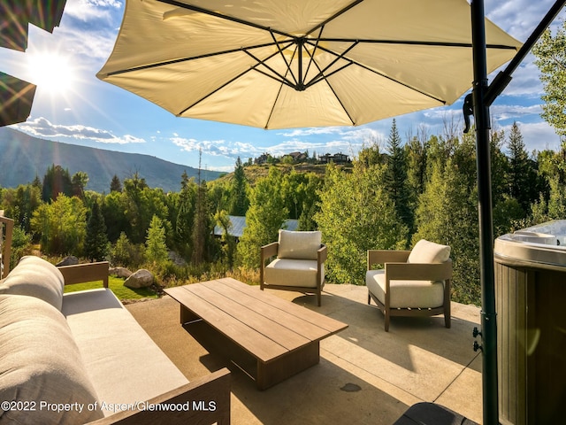 view of patio / terrace with a mountain view and an outdoor living space