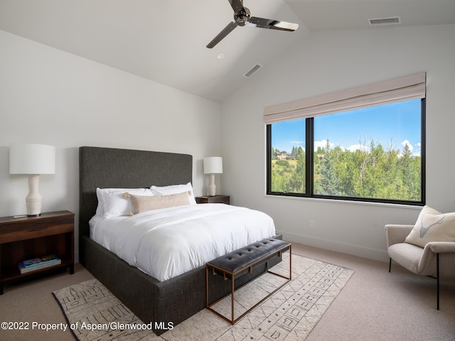 bedroom featuring ceiling fan, light colored carpet, and lofted ceiling