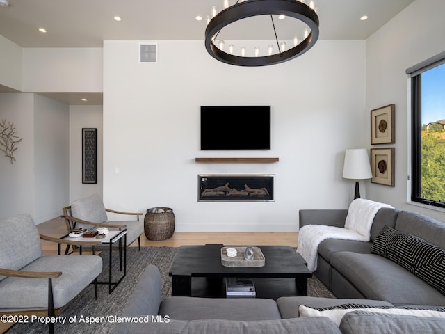 living room with an inviting chandelier and hardwood / wood-style floors