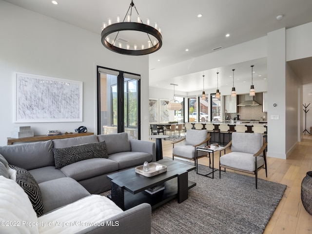 living room with a chandelier and light hardwood / wood-style floors