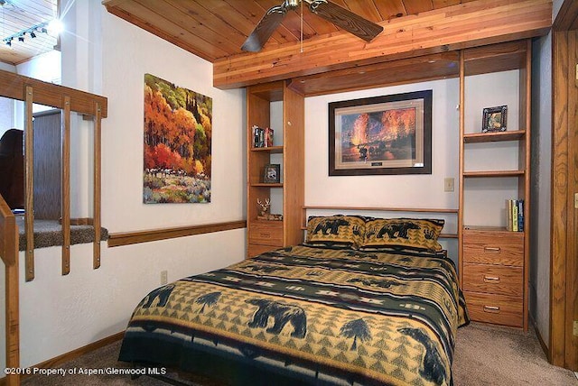 bedroom featuring track lighting, ceiling fan, beam ceiling, wooden ceiling, and carpet floors