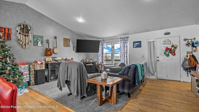 living room featuring hardwood / wood-style floors and vaulted ceiling