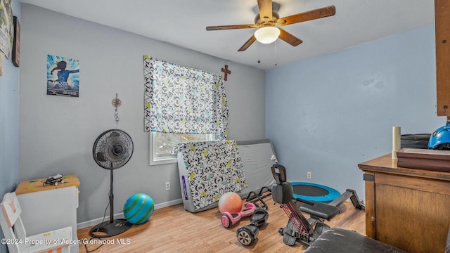 exercise room with wood-type flooring and ceiling fan