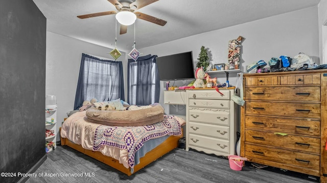 bedroom featuring a textured ceiling, ceiling fan, and dark wood-type flooring