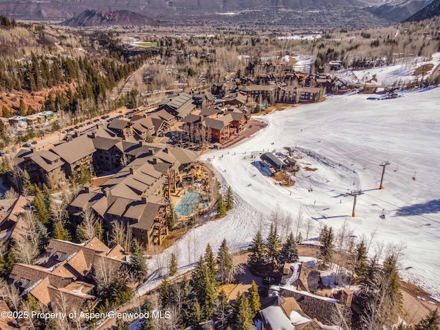 snowy aerial view with a mountain view