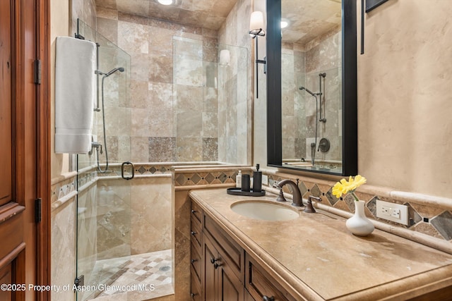 full bath featuring a stall shower and vanity