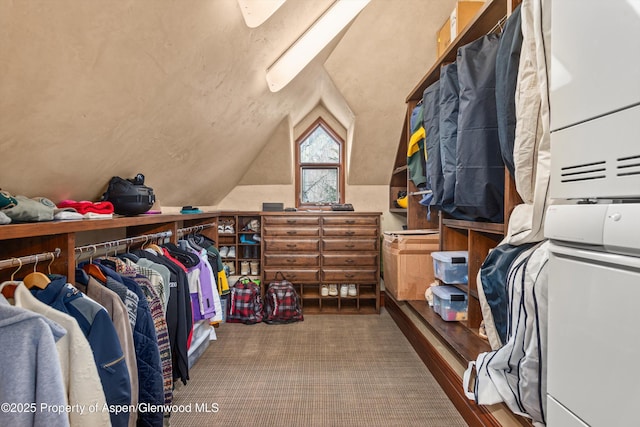 spacious closet featuring lofted ceiling and carpet flooring