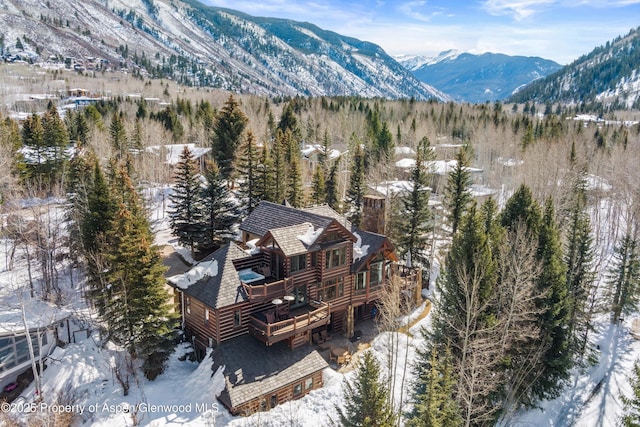 snowy aerial view with a mountain view