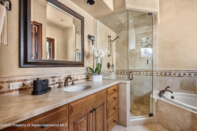 bathroom with a garden tub, a shower stall, and vanity